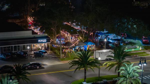 Shoppers browsing vendor tents at Market on Fifth (Apopka Night Market)