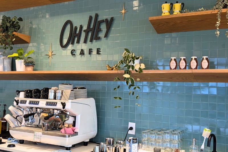A barista pouring latte art during a throwdown competition at Oh Hey Cafe