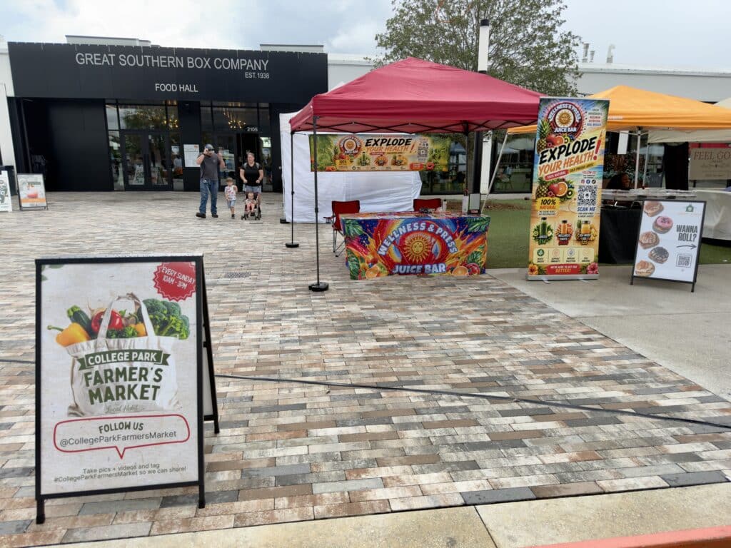 Shoppers browsing vendor tents at College Park Farmers Market
