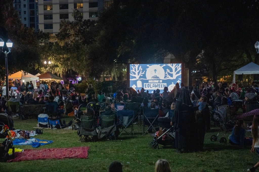 Families in costumes on the east lawn at Lake Eola during Eolaween