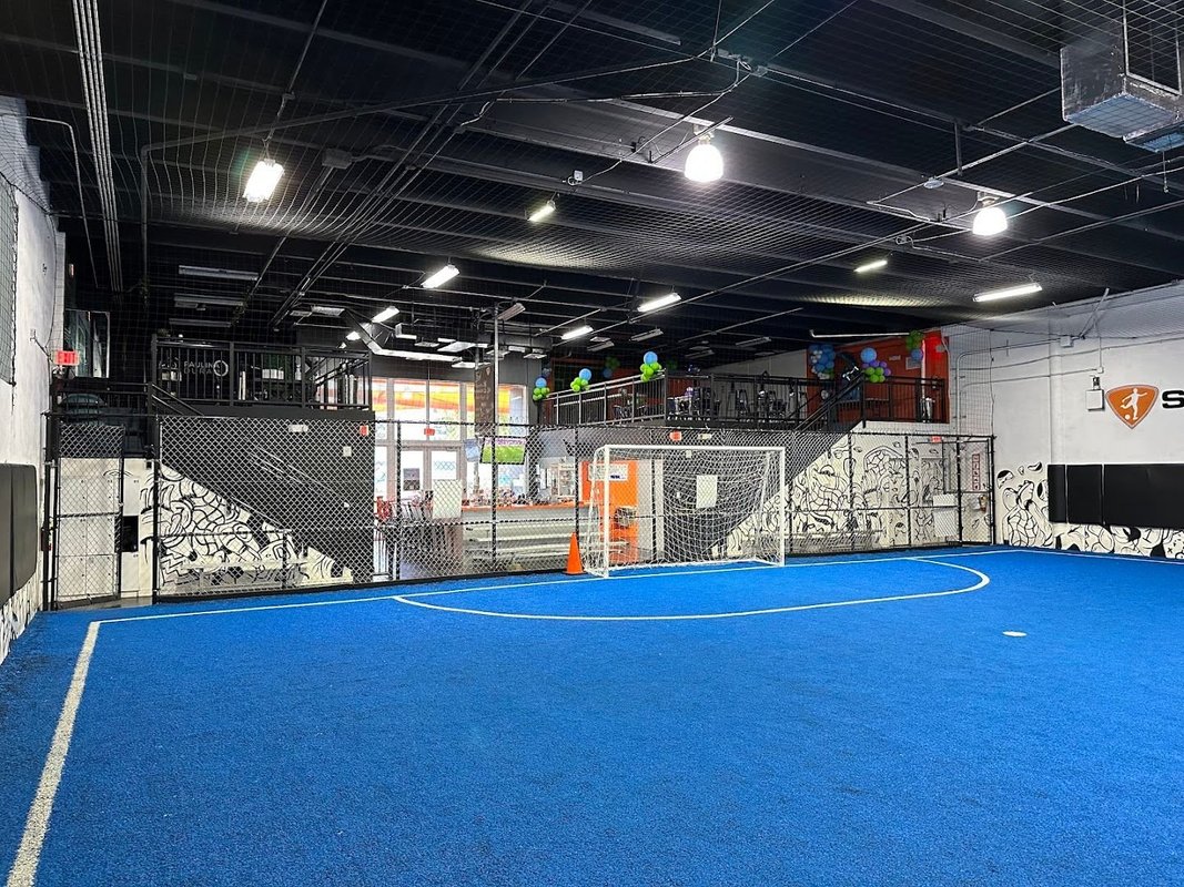 A competitive indoor pickup soccer game at High Soccer Arena in Orlando