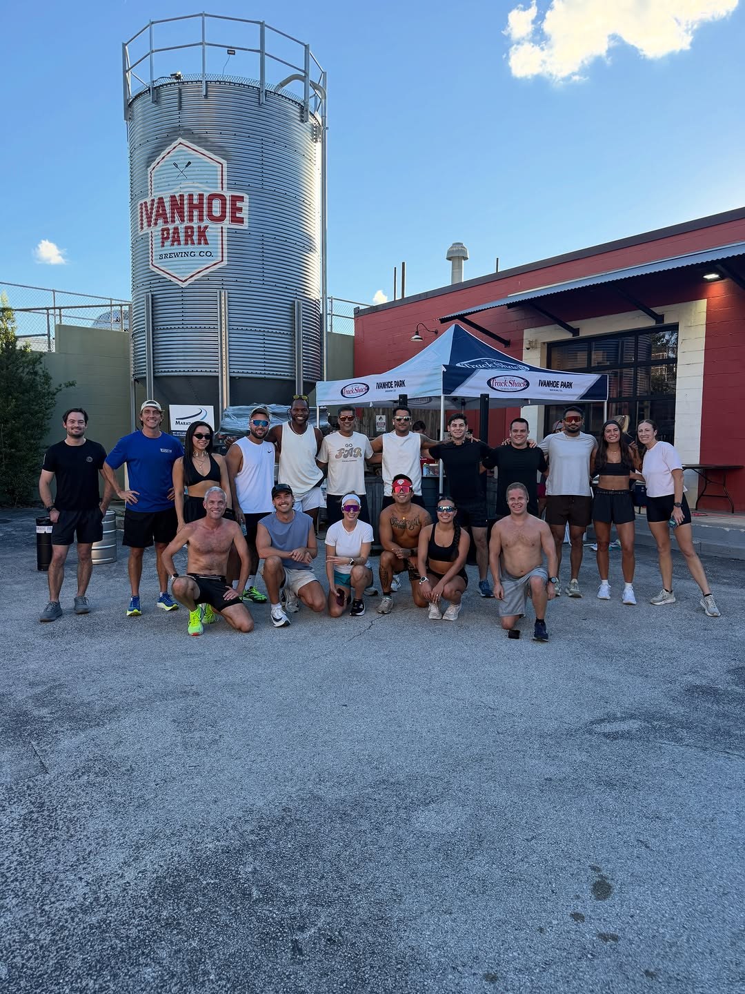 Run club members jogging together on an Orlando street at dusk