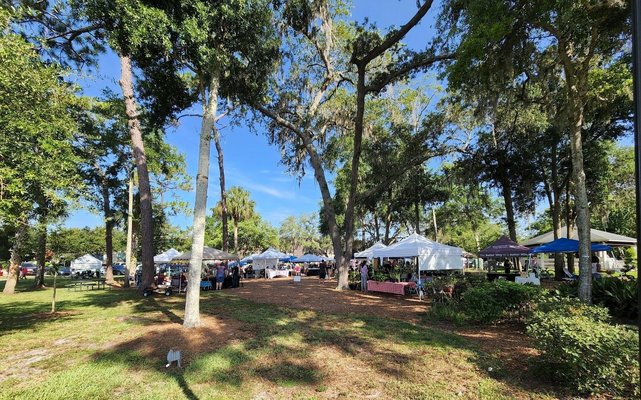 Shoppers browsing vendor tents at Lake Mary Farmers Market