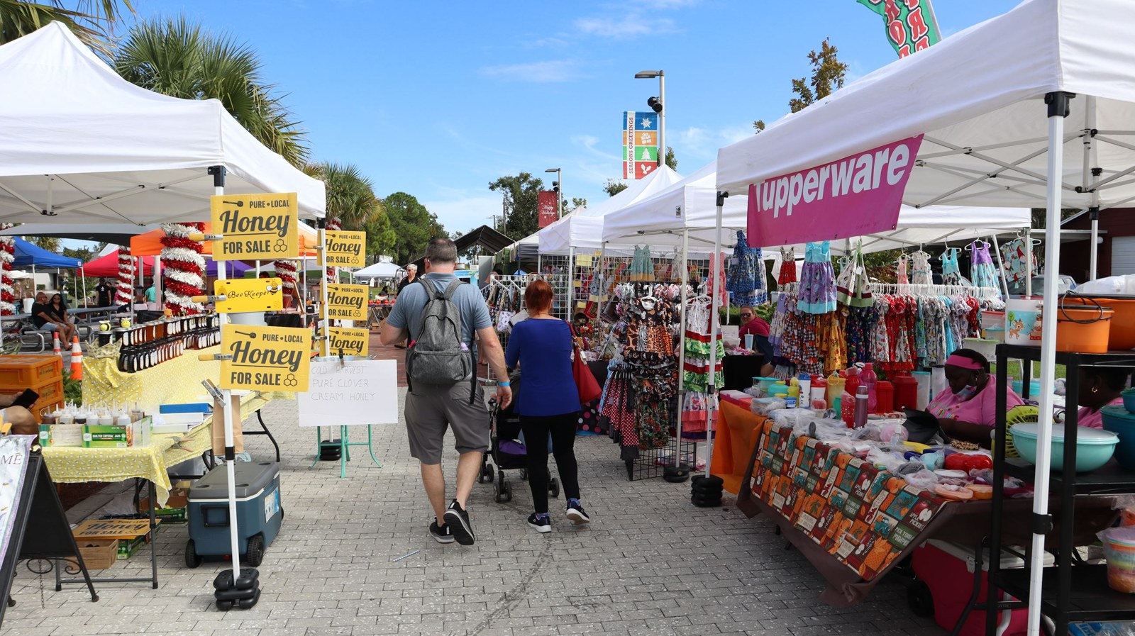 Shoppers browsing vendor tents at City of Longwood Farmers Market