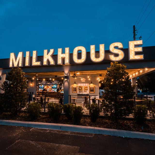 A book club group talking over drinks at the Milkhouse bar