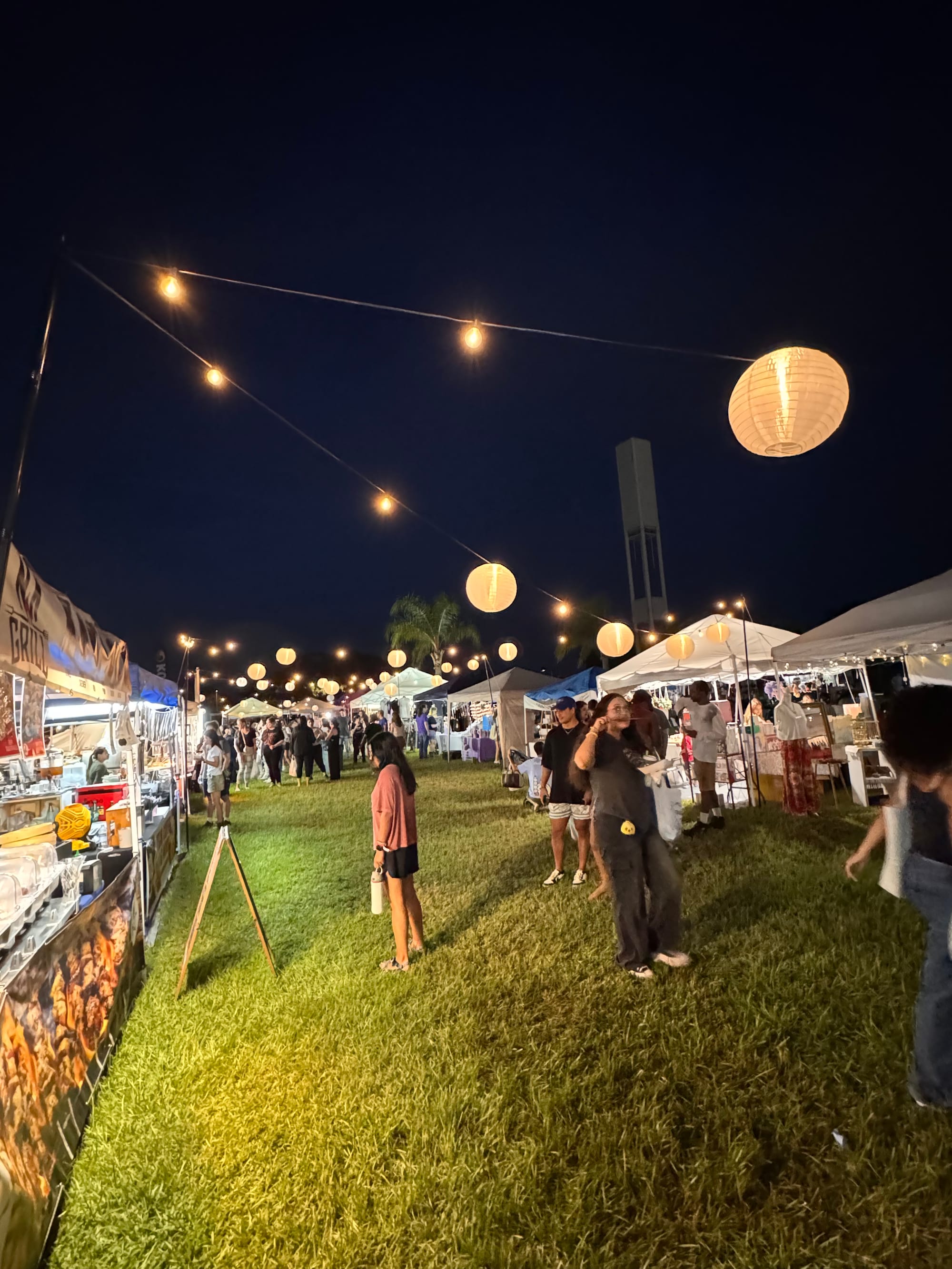 Evening crowds browsing Korean food stalls at the Seoul Dalbam Night Market in Avalon Park
