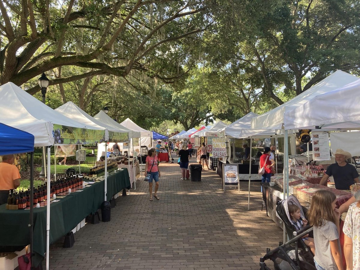 Shoppers browsing vendor tents at Windermere Farmers Market